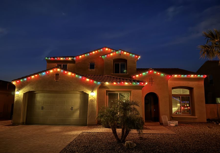 Two-story home at twilight with a multicolor roofline